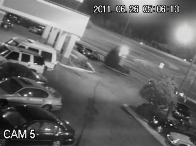 In this June 26, 2011 frame grab from a security video, a pickup truck can barely be seen hitting James Craig Anderson, a 49-year-old black man on a Jackson, Miss., street in the top right corner of the frame. The truck's driver, Deryl Dedmon, a white teen, is accused of having driven out of the parking lot and having run down James Craig Anderson, a 49-year-old black man, on the Jackson street. The incident, stoked in part by security camera footage showing Anderson being run over, is causing people across the country to sound off on social media pages created for and against the defendants. (AP Photo)